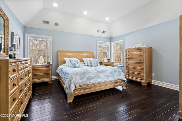 bedroom with dark hardwood / wood-style floors, lofted ceiling, and a tray ceiling