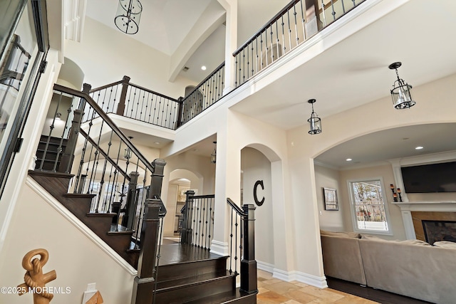 foyer featuring a towering ceiling and ornamental molding