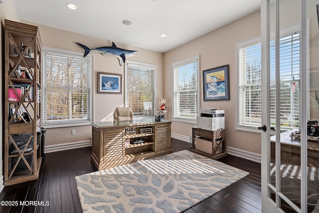 home office with a healthy amount of sunlight, dark hardwood / wood-style flooring, and french doors