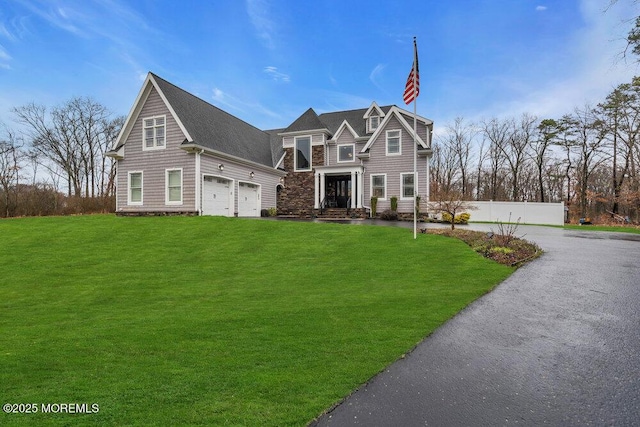 view of front of home featuring a front lawn and a garage