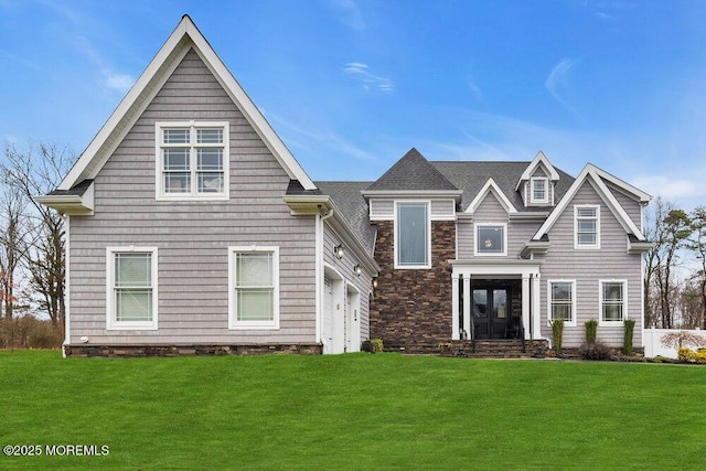 view of front facade with french doors, a garage, and a front lawn