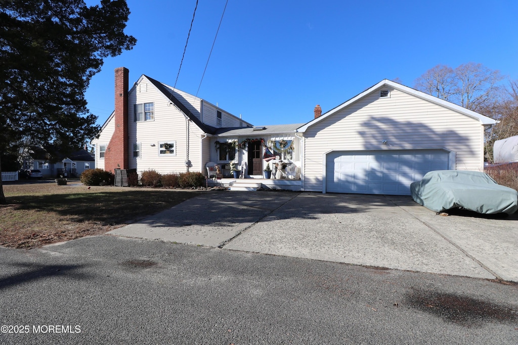 view of front of property featuring solar panels and a garage