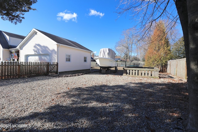 view of side of property with a garage and fence