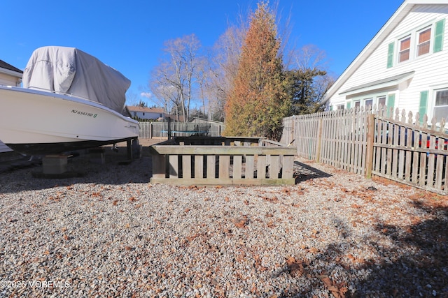 view of yard with a fenced backyard and a trampoline