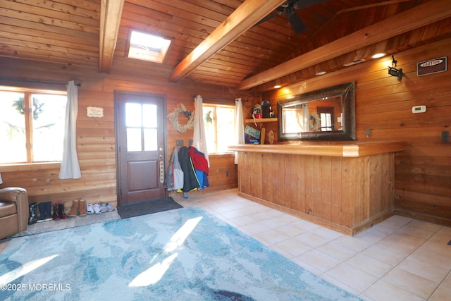 tiled foyer entrance featuring wood walls, a dry bar, vaulted ceiling with beams, and wooden ceiling