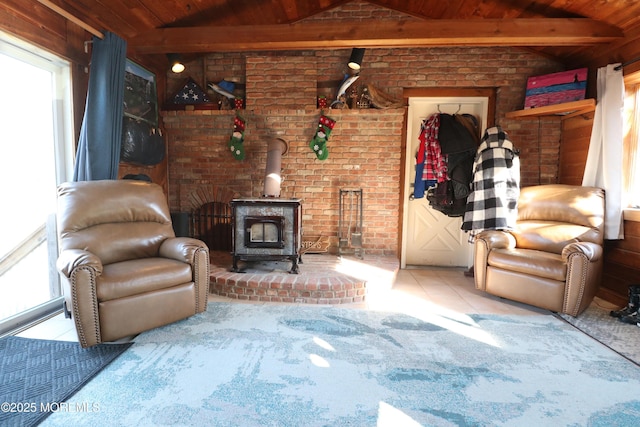 tiled living area with a wood stove, vaulted ceiling with beams, and wood ceiling