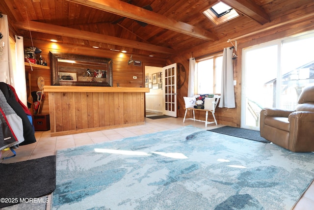 tiled living area with lofted ceiling with beams, wooden walls, wood ceiling, and a bar