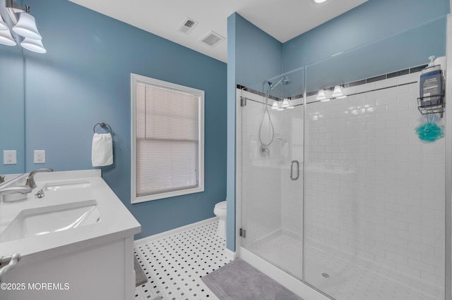 bathroom featuring vanity, toilet, and an enclosed shower