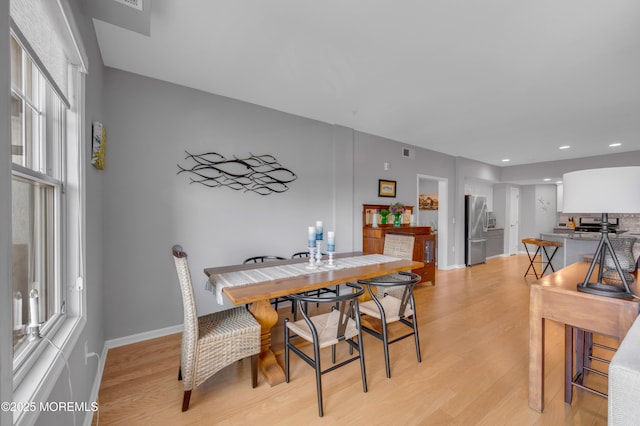 dining area with light hardwood / wood-style floors