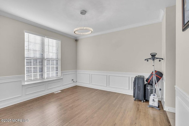 empty room featuring crown molding and hardwood / wood-style flooring