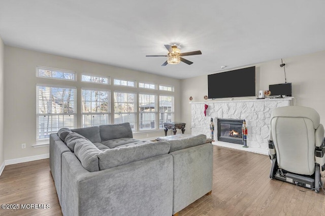 living room with hardwood / wood-style flooring, a fireplace, and ceiling fan