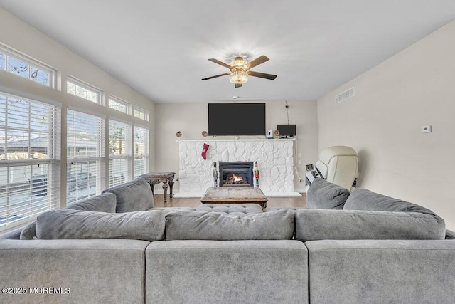 living room with hardwood / wood-style floors, a fireplace, and ceiling fan