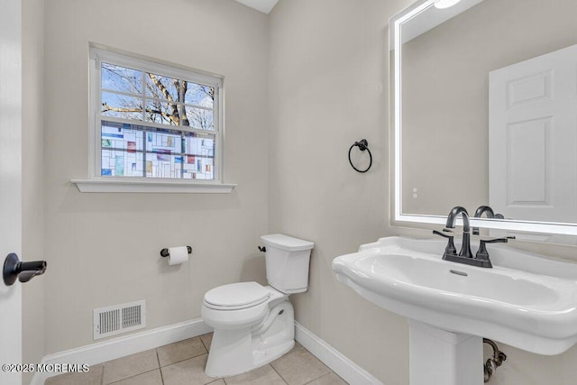 bathroom with tile patterned flooring, sink, and toilet