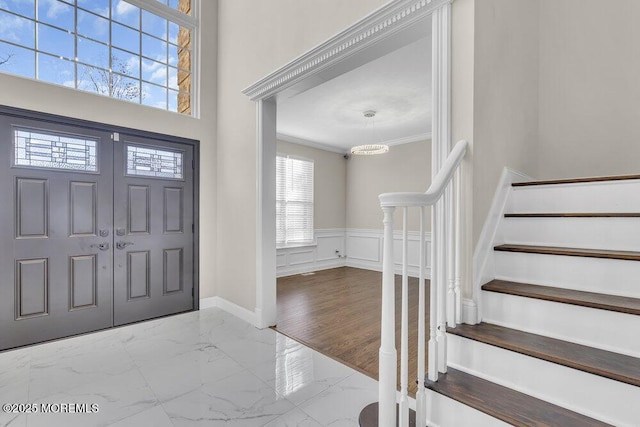 entryway featuring crown molding