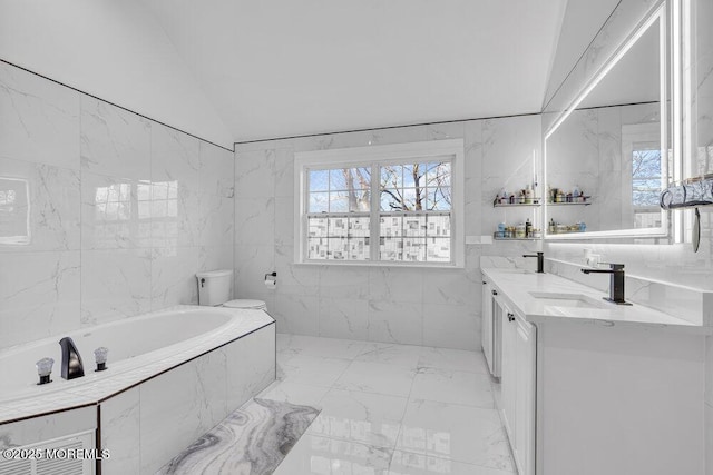 bathroom with lofted ceiling, tile walls, vanity, a wealth of natural light, and toilet