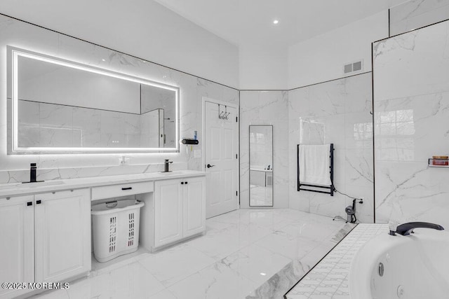 bathroom featuring a washtub and vanity