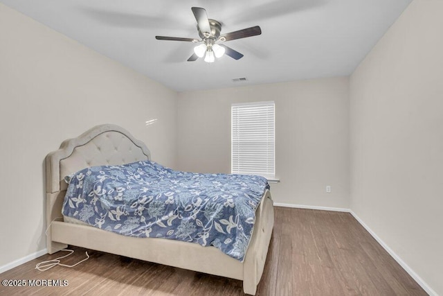 bedroom with hardwood / wood-style flooring and ceiling fan