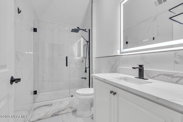 bathroom with lofted ceiling, a shower with door, tile walls, vanity, and toilet