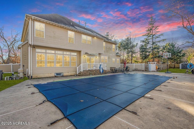 pool at dusk with a patio