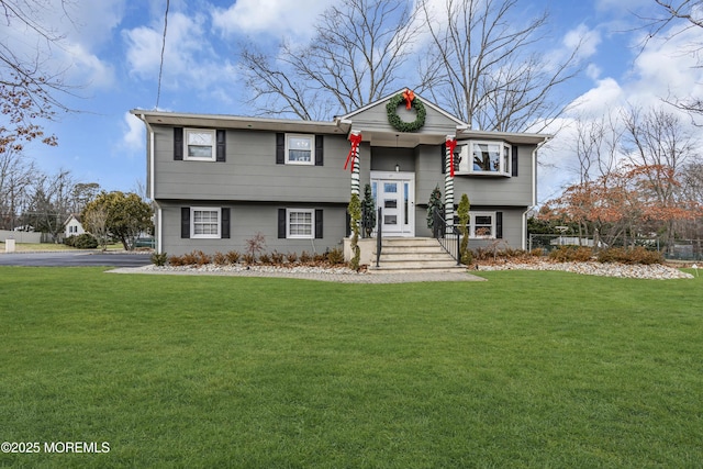 bi-level home with a front lawn