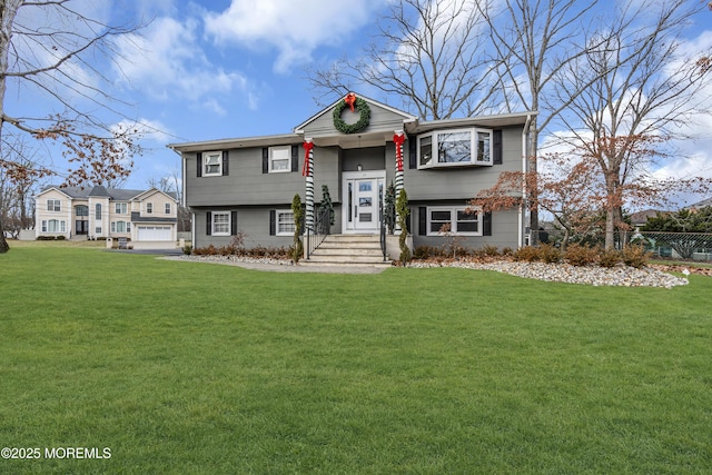 raised ranch with a front yard