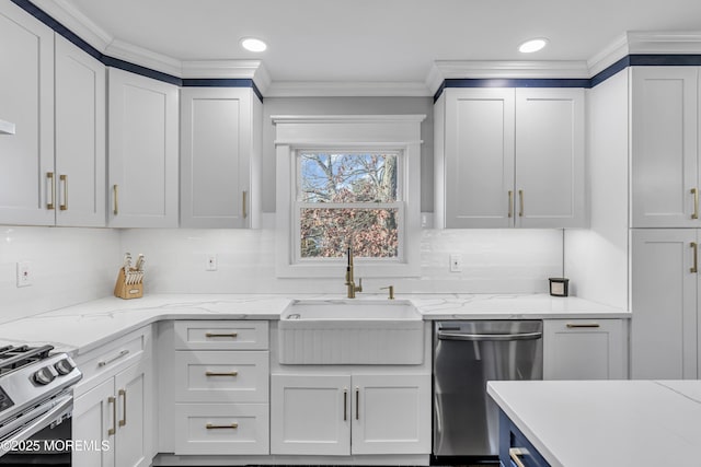 kitchen with ornamental molding, a sink, appliances with stainless steel finishes, white cabinets, and decorative backsplash