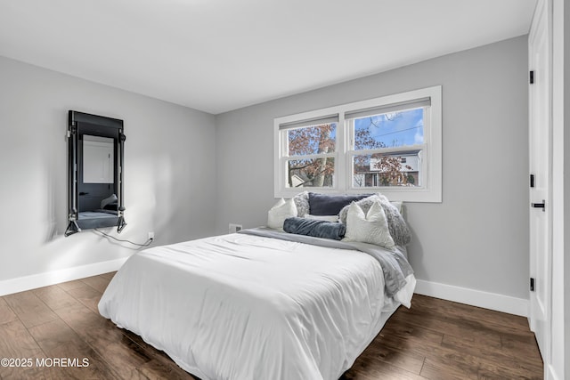 bedroom featuring dark wood-style floors and baseboards