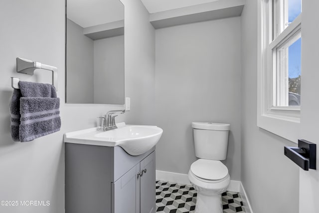 bathroom featuring tile patterned floors, toilet, vanity, and baseboards