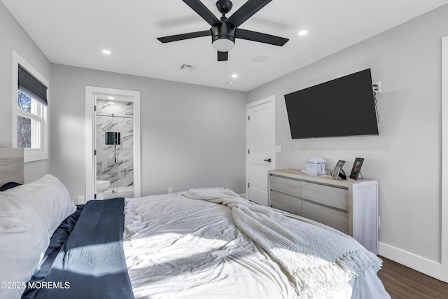 bedroom with visible vents, baseboards, dark wood finished floors, recessed lighting, and ensuite bath