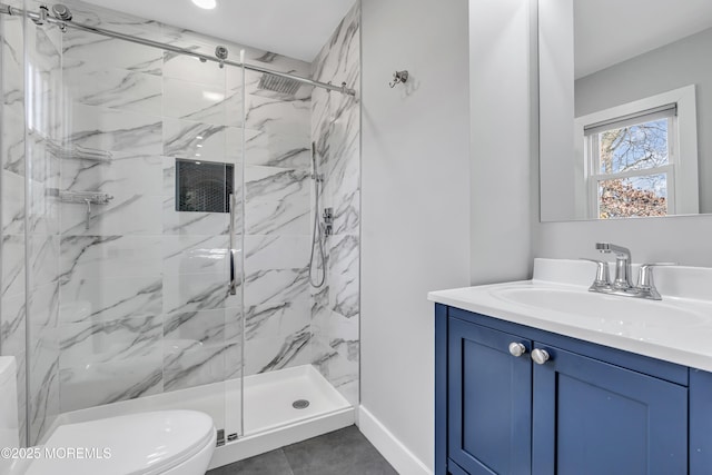 full bath featuring a marble finish shower, toilet, and vanity