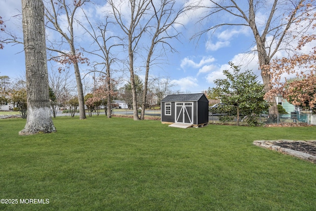 view of yard featuring an outdoor structure, a storage unit, and fence private yard