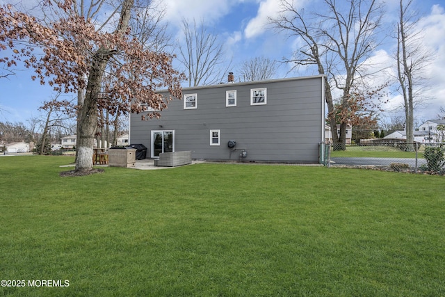 back of property with a patio area, a yard, and fence