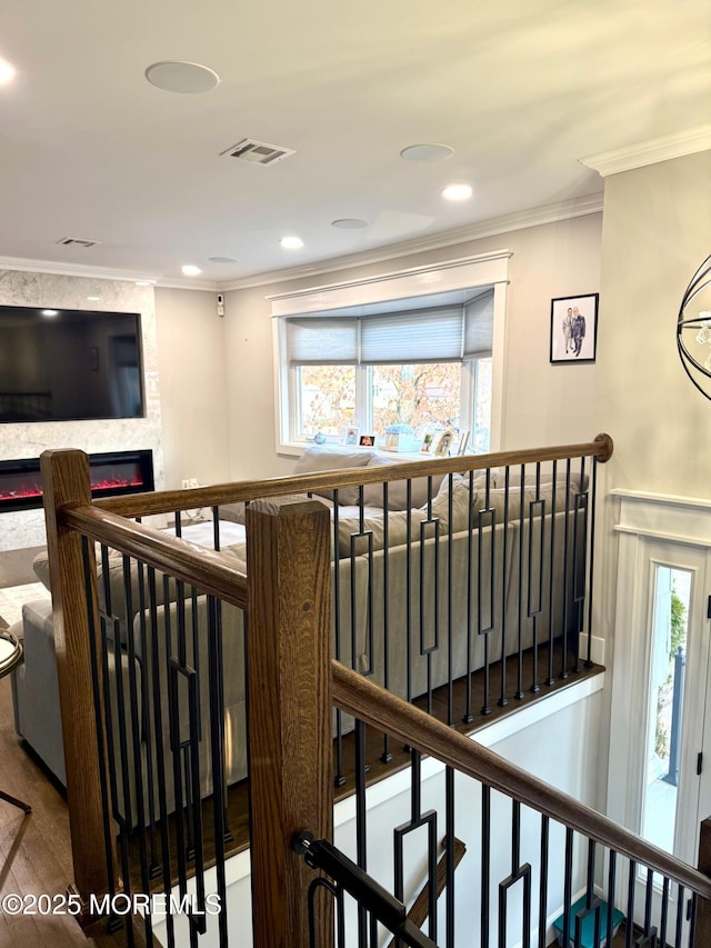 corridor featuring visible vents, an upstairs landing, wood finished floors, recessed lighting, and crown molding