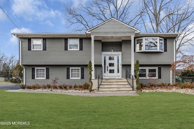 raised ranch featuring a front lawn