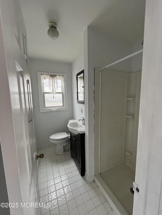 bathroom with walk in shower, tile patterned flooring, vanity, and toilet