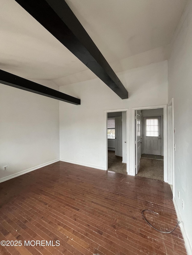 empty room with lofted ceiling with beams and dark hardwood / wood-style floors