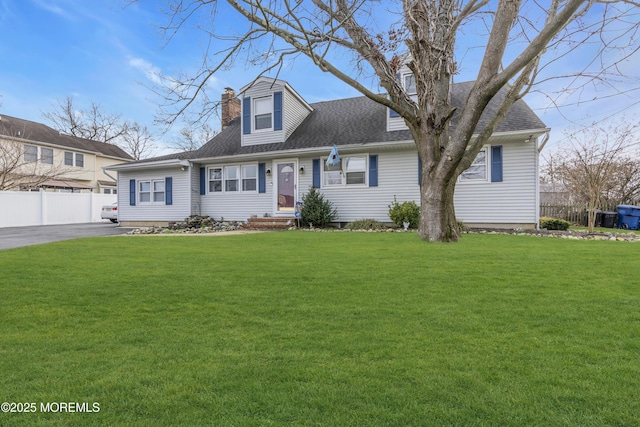 cape cod home featuring a front yard