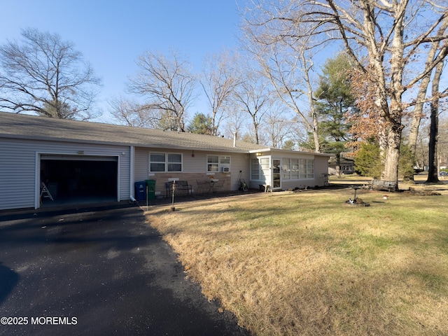 back of property with a yard and a garage