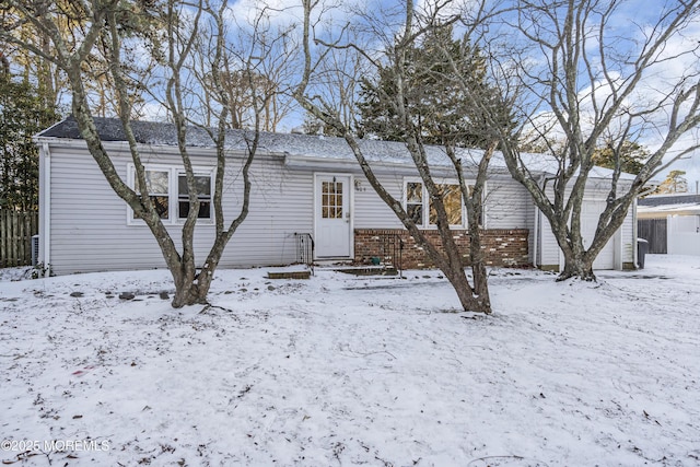 view of snow covered back of property