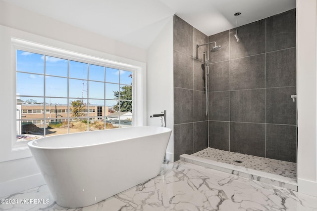 bathroom featuring separate shower and tub