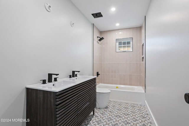 full bathroom featuring vanity, tile patterned floors, tiled shower / bath combo, and toilet