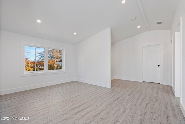interior space featuring light hardwood / wood-style flooring and lofted ceiling