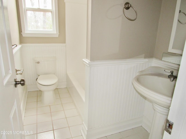 bathroom featuring tile patterned flooring, toilet, and sink