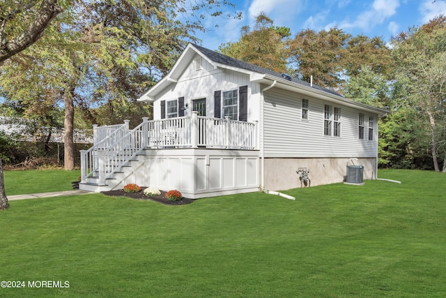 view of home's exterior featuring a wooden deck, a yard, and cooling unit