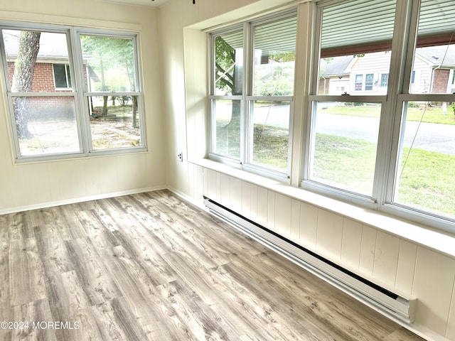 unfurnished sunroom with baseboard heating