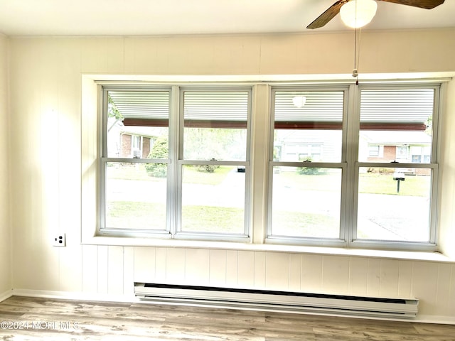 entryway with hardwood / wood-style floors, ceiling fan, a healthy amount of sunlight, and a baseboard radiator