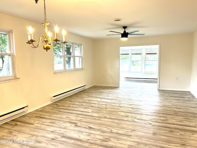 unfurnished room with ceiling fan with notable chandelier, light hardwood / wood-style floors, and baseboard heating