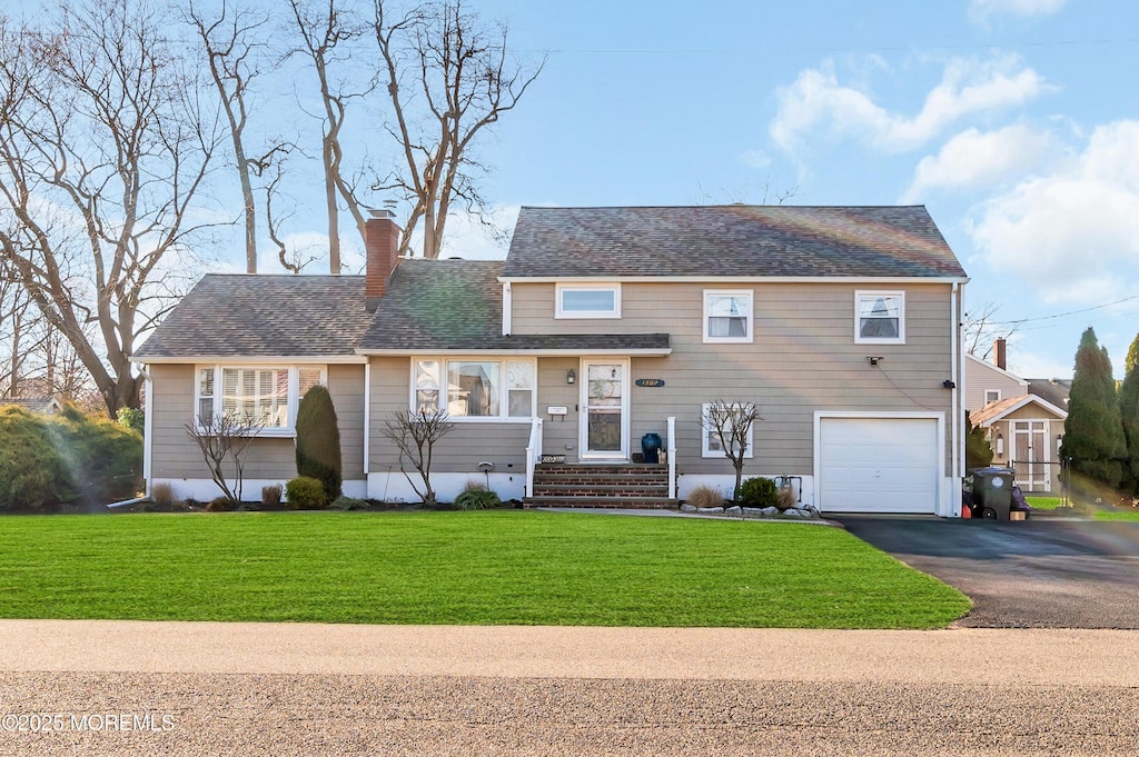 split level home with a front lawn and a garage