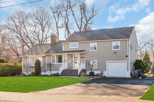 view of front of house featuring a front lawn and a garage