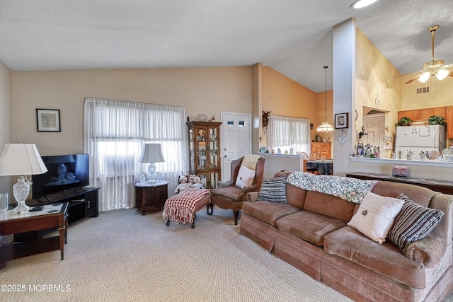 carpeted living room with high vaulted ceiling, a textured ceiling, and ceiling fan